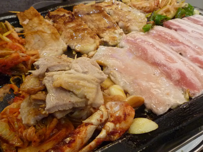李さんの台所でサムギョプサル(サムギョッサル)・韓国料理食べ放題の巻：焼いていると油が出ますが、その下流にキムチやニンニクを置いておくと美味しく仕上がりますよ。